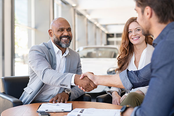 Two professionals shaking hands during a business meeting.