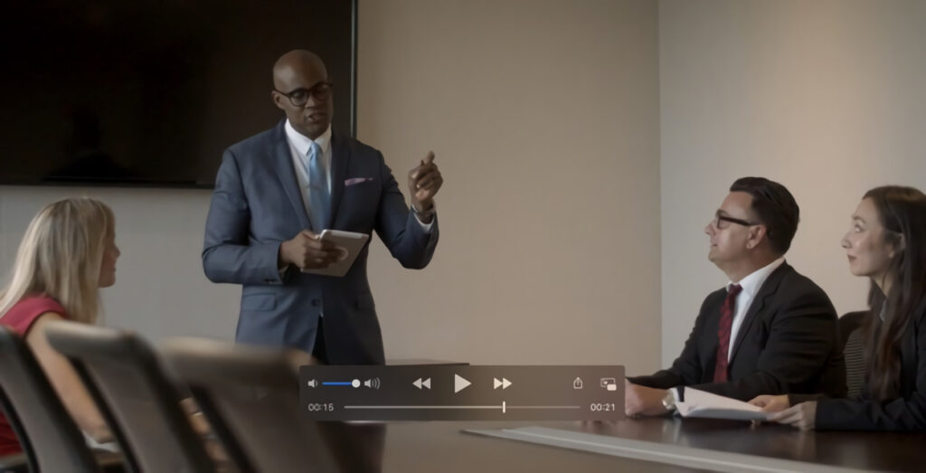 Professional business meeting with a man presenting and another listening.