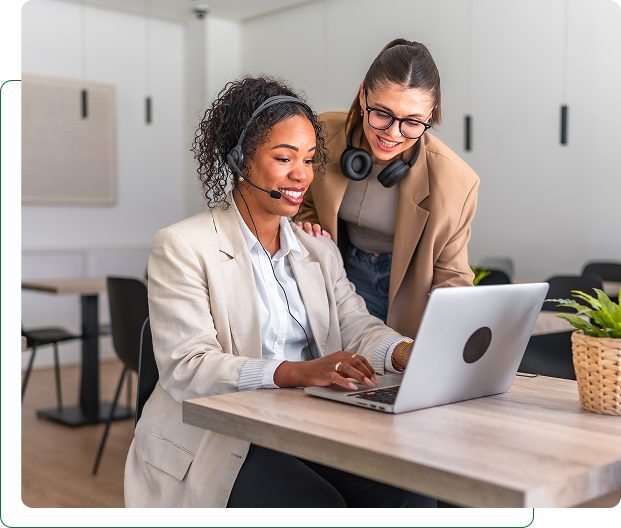Two women collaborating on a laptop