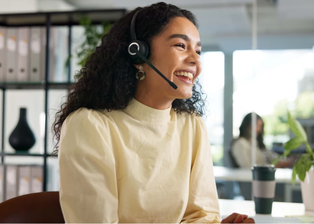 Woman smiling while wearing a headset