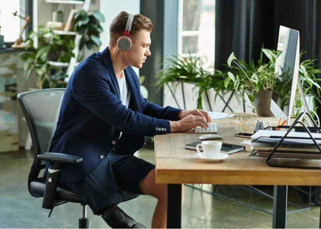 Man working at desk with headphones