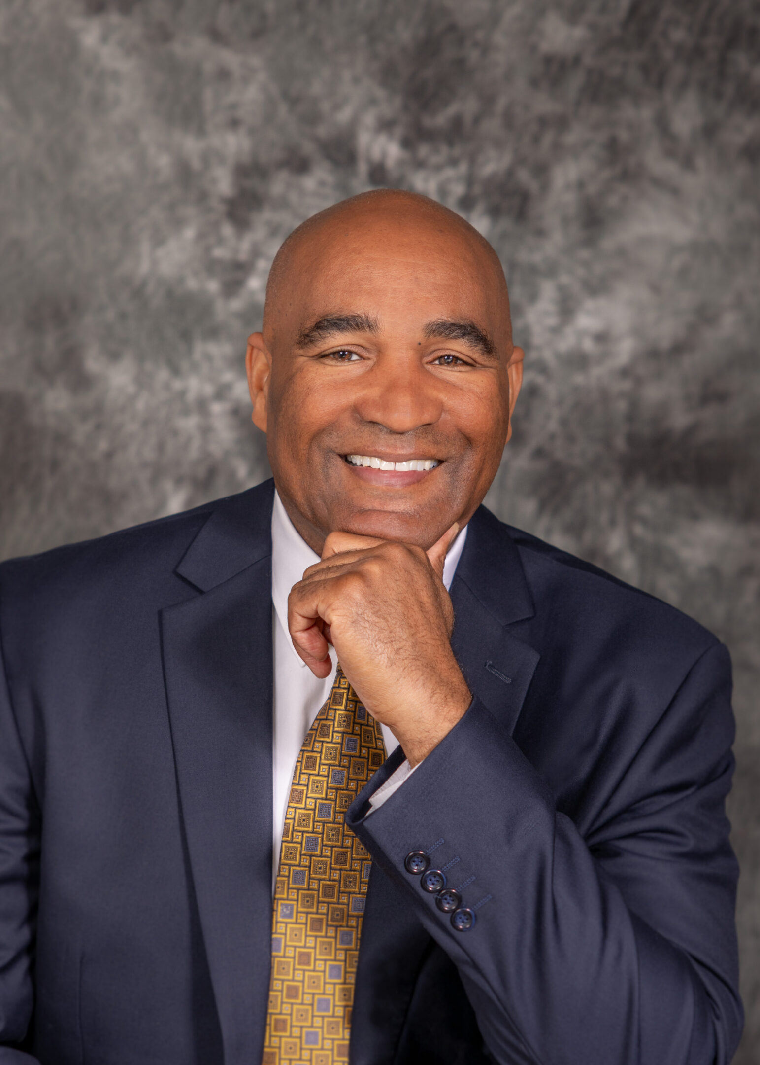 Smiling bald businessman in suit and tie