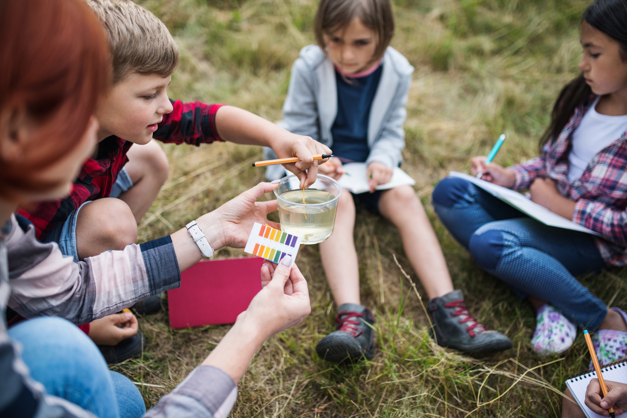 Kids testing water pH outdoors