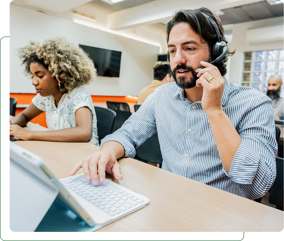 Call center agents with headsets at computers