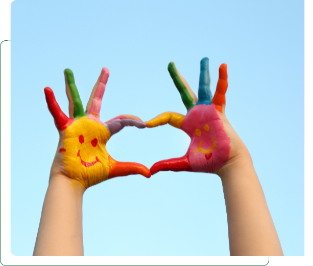 Colorful painted hands forming heart with smiles