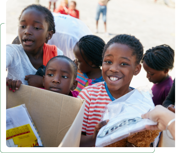 Smiling children receiving donated supplies